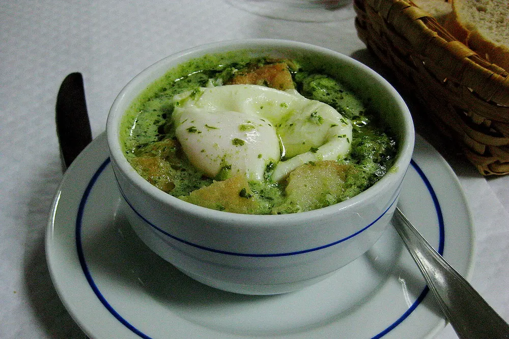 Açorda à alentejana — garlic-and-coriander bread soup with a poached egg