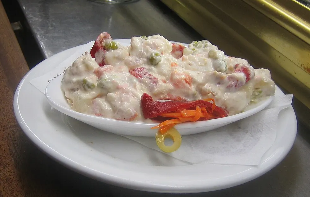 Ensaladilla rusa — Spanish potato salad in mayonnaise with piquillo pepper