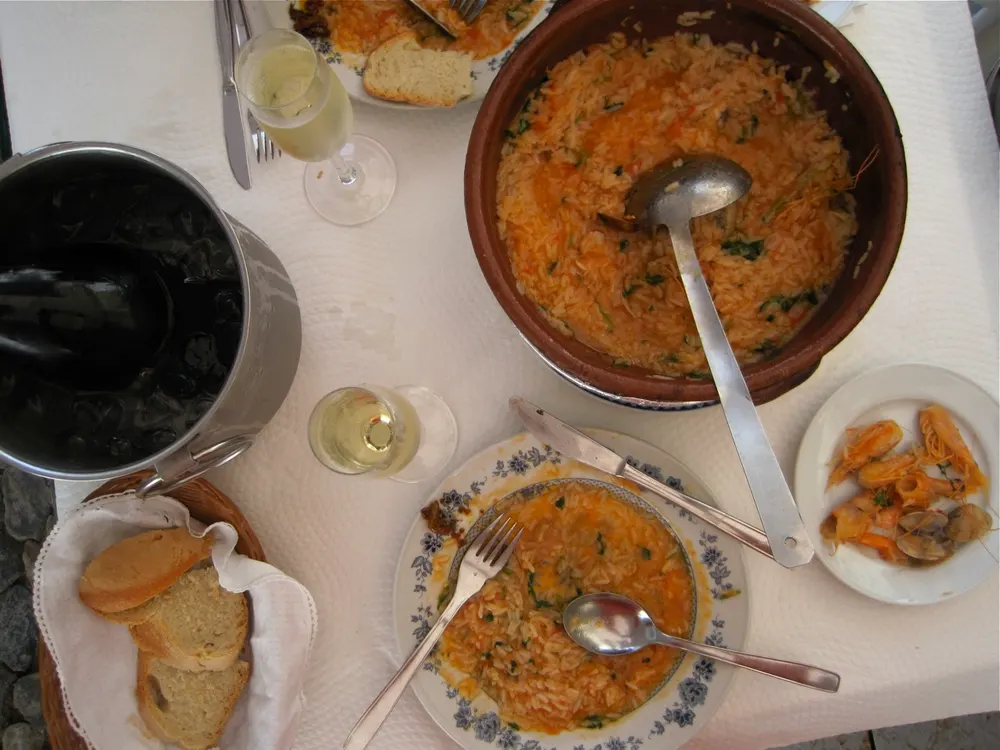 Arroz de marisco — soupy Portuguese seafood rice served in a clay pot