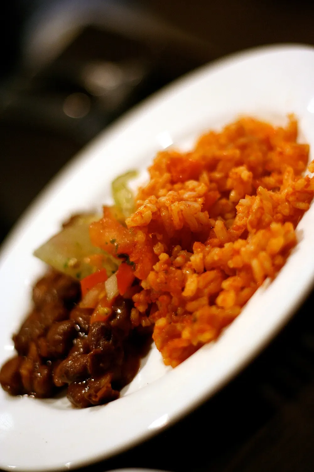 Arroz rojo — Mexican tomato-red rice, served with refried beans