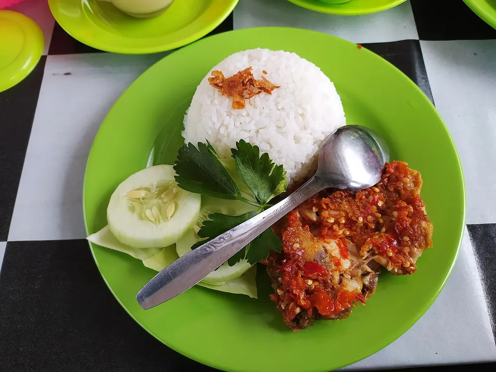 Ayam geprek — crispy fried chicken smashed with fiery sambal, served with rice