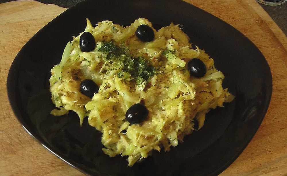 Bacalhau à Brás — shredded salt cod with straw potatoes, egg and olives