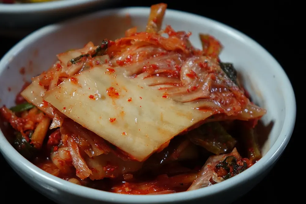 A dish of red napa cabbage kimchi