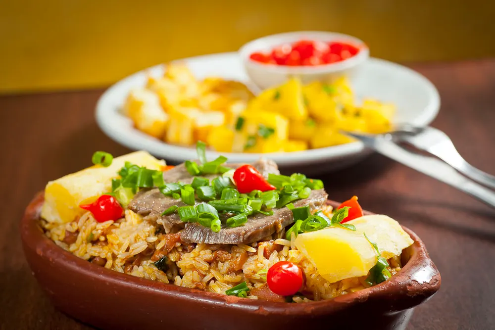 Rice and beans cooked with beef, cheese and scallions