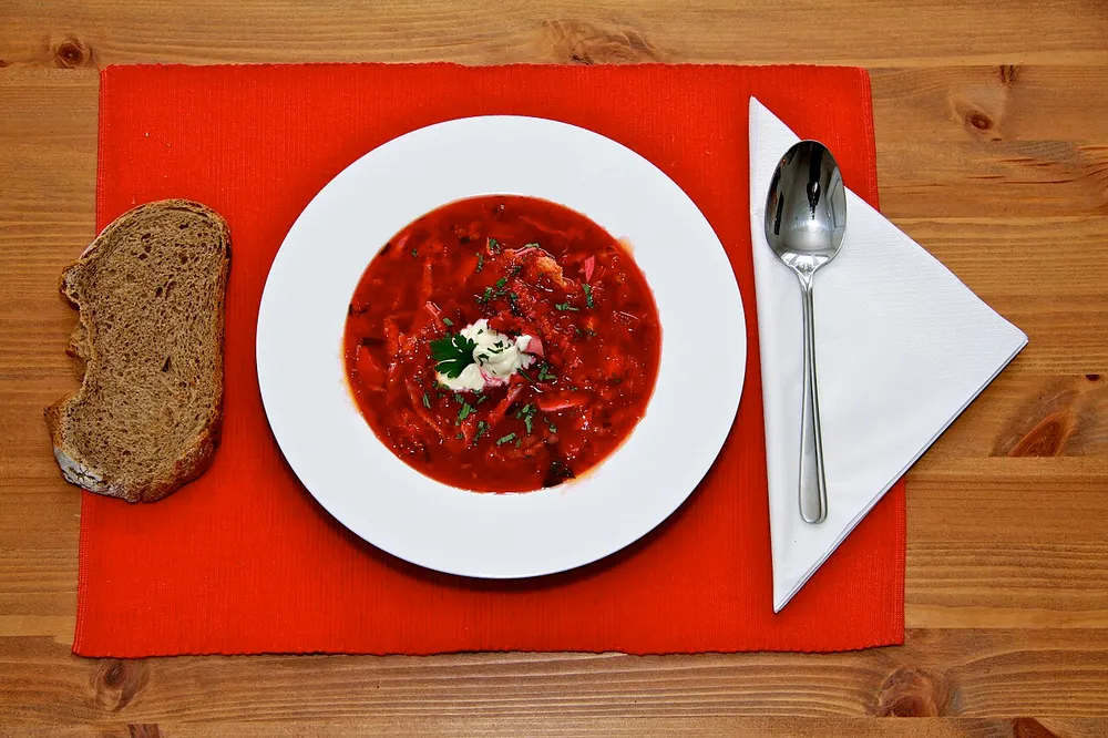 Barszcz czerwony — clear red beetroot soup with sour cream and rye bread