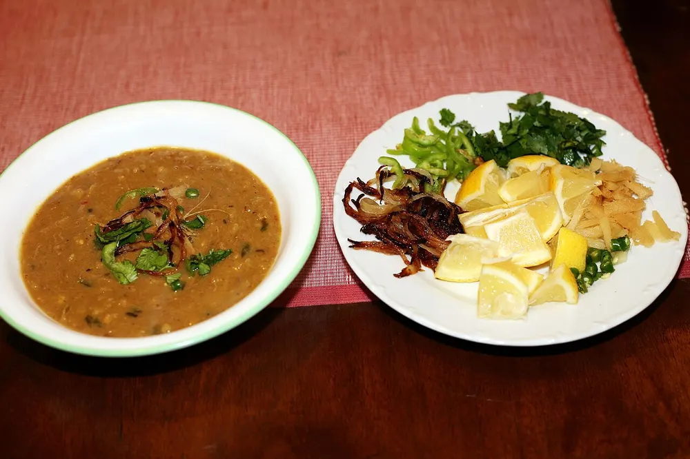 Beef haleem — thick porridge of beef, lentils and wheat, with fried-onion garnish