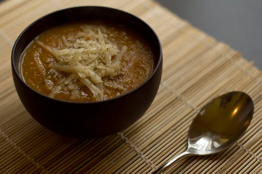 Vellutata di zucca — smooth pumpkin velouté with grated cheese and pepper