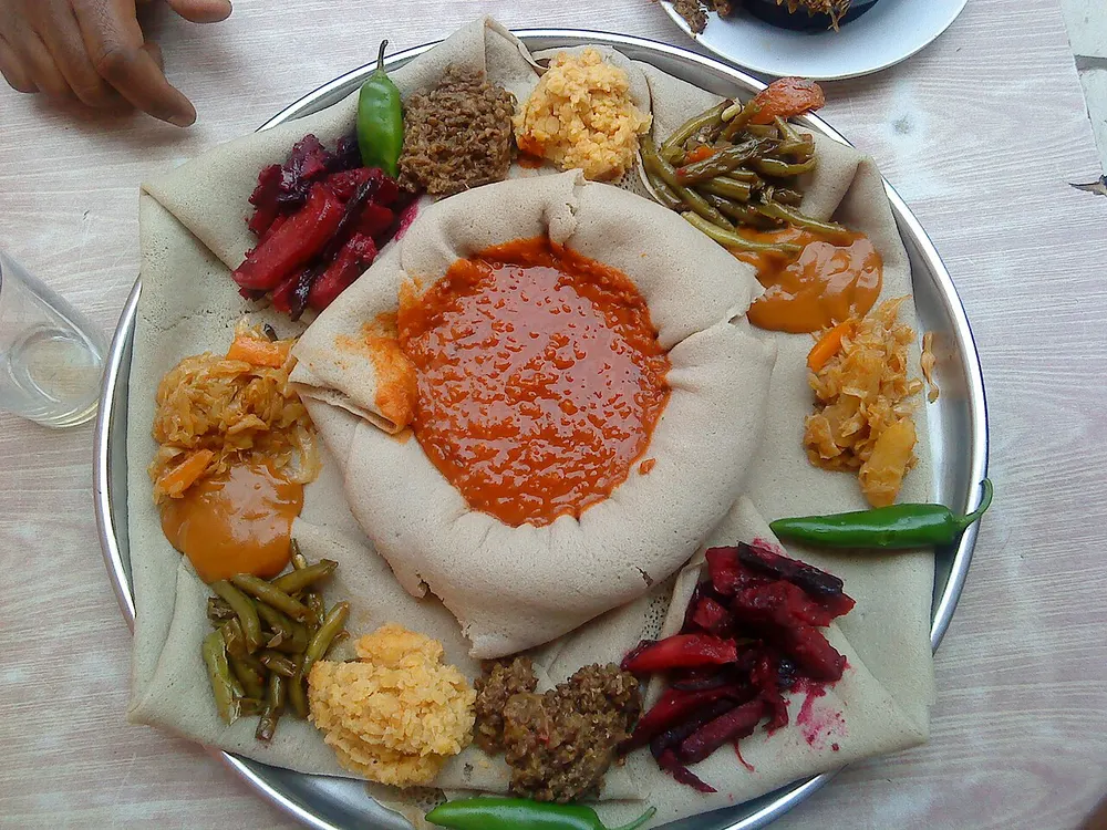 Beyaynetu — a platter of vegan stews arranged around injera