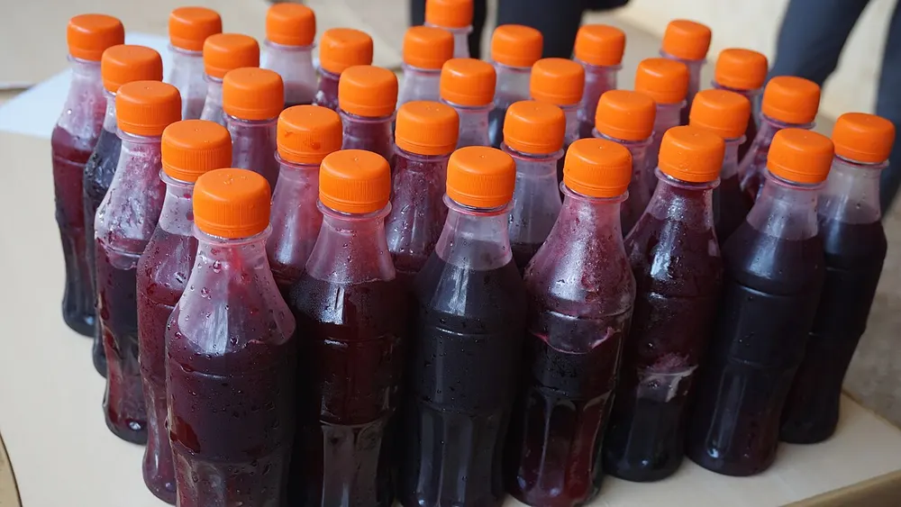 Bissap — chilled hibiscus drink bottled for sale, deep crimson