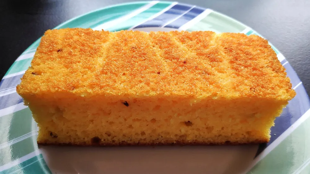 A slice of golden Brazilian cornmeal cake