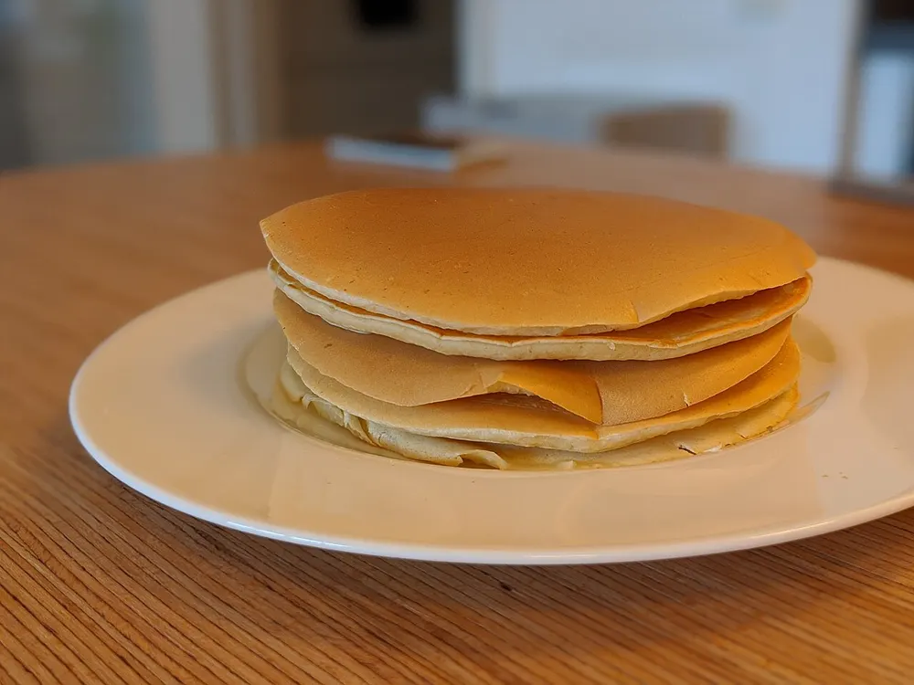 A stack of fluffy buttermilk pancakes on a plate