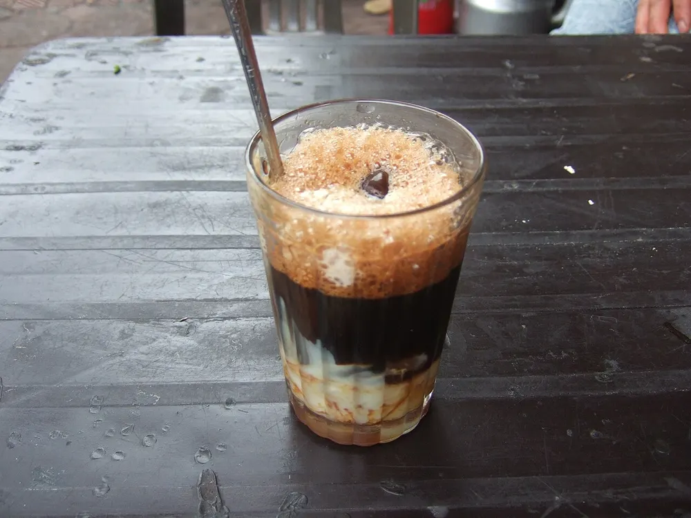 Cà phê sữa đá — Vietnamese iced coffee layered over sweetened condensed milk