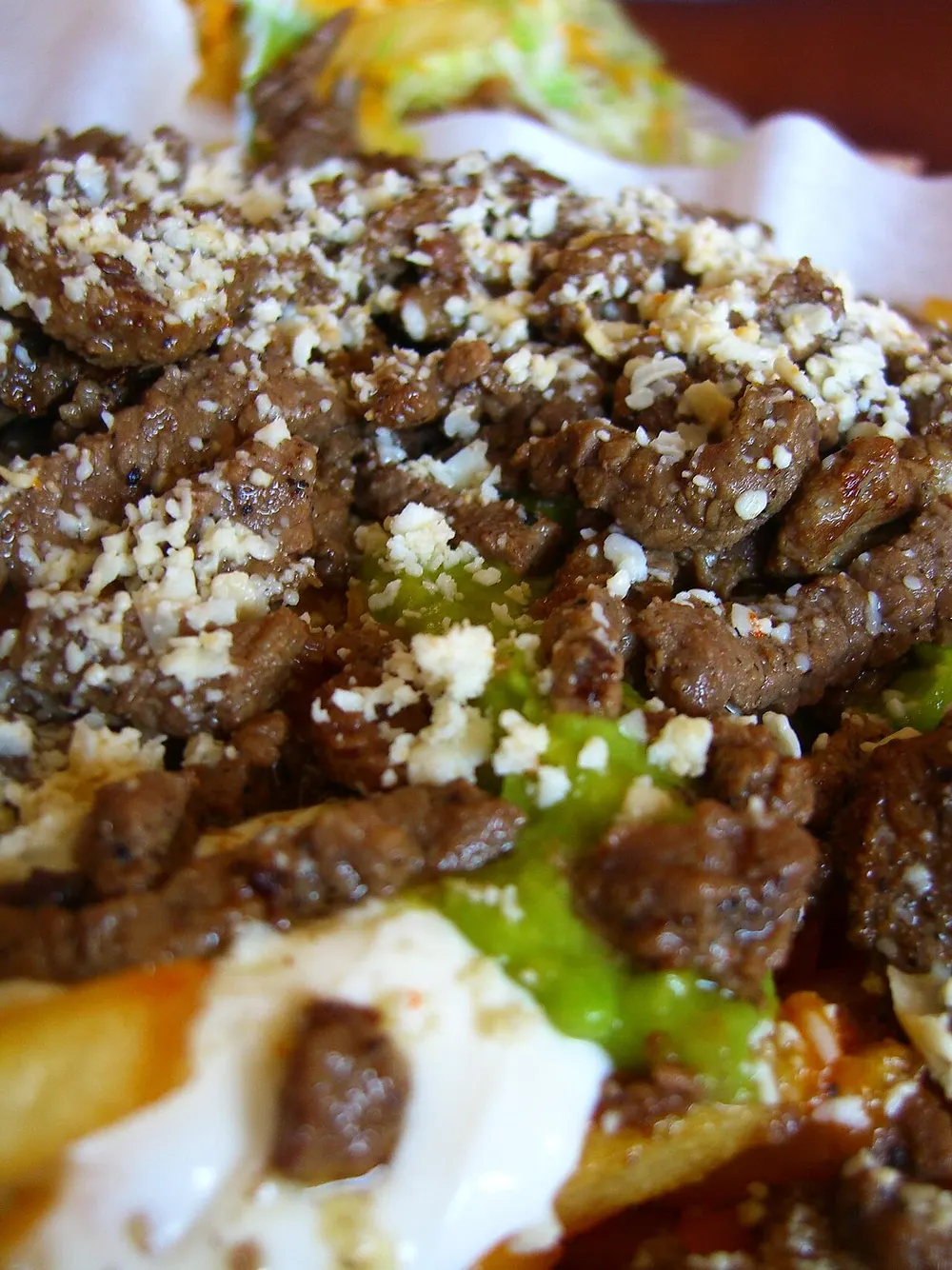 Carne asada — grilled beef with guacamole and crumbled cheese