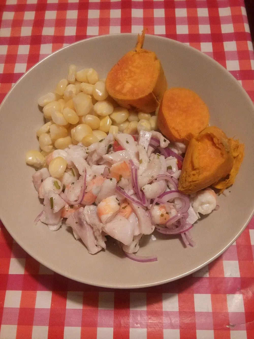 Ceviche of white fish with red onion, served with sweet potato and choclo corn