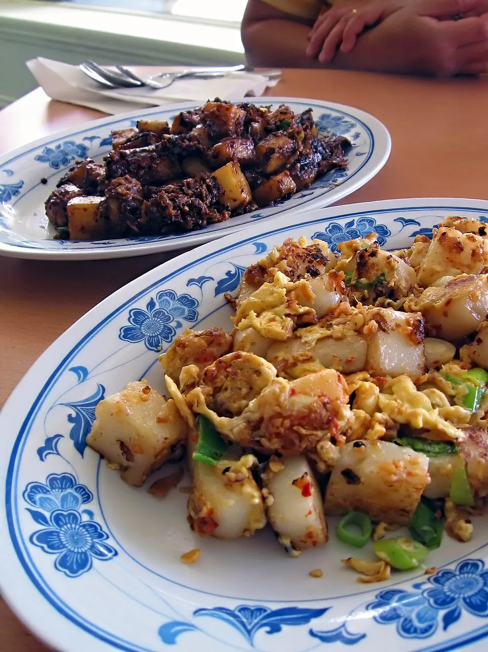 Chai tow kway — radish cake cubes fried with egg, in white and black versions