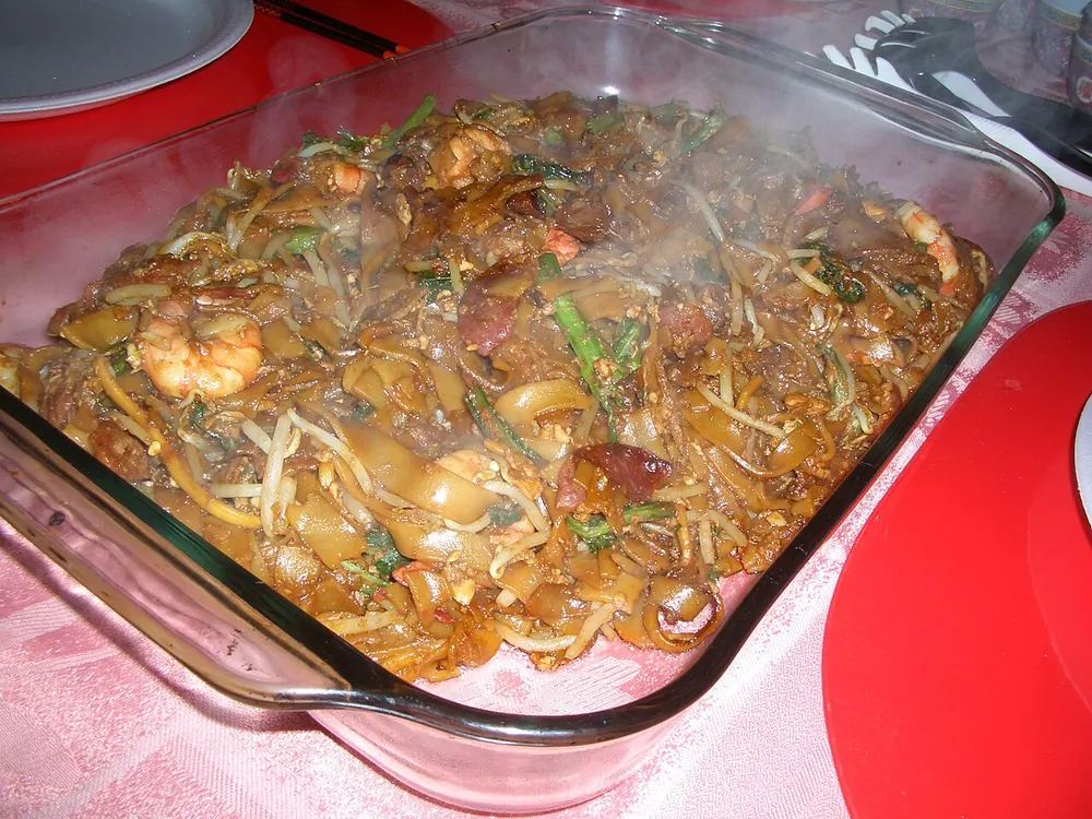 Char kway teow — flat rice noodles wok-fried with prawns, cockles and sausage