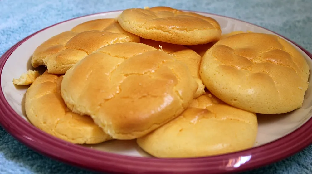 Pale golden rounds of whipped-egg-white cloud bread piled on a plate
