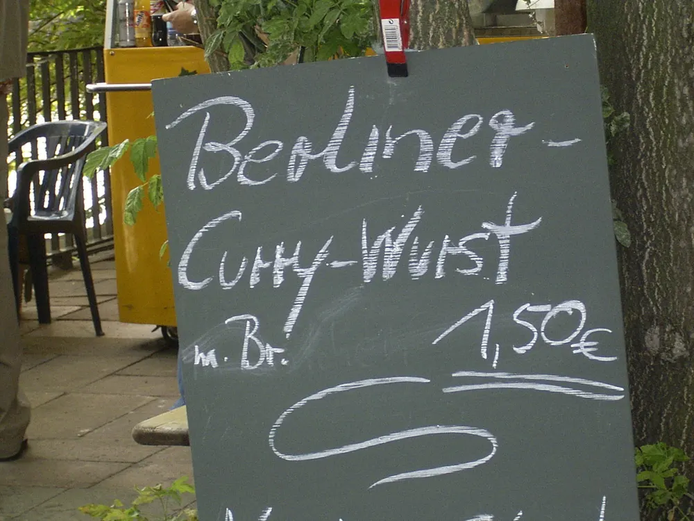 Currywurst — sliced fried sausage in curried ketchup, dusted with curry powder