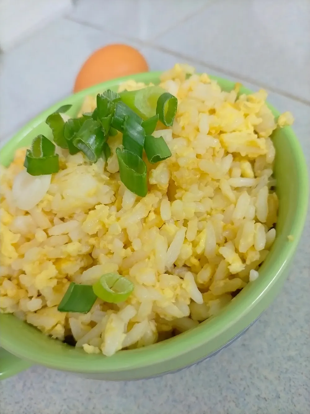 A plate of Chinese egg fried rice with scallions