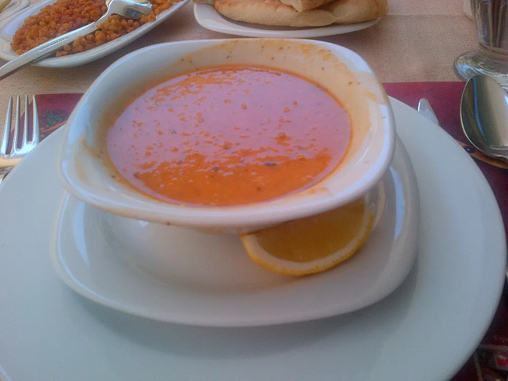 A bowl of orange-red ezogelin lentil-and-bulgur soup