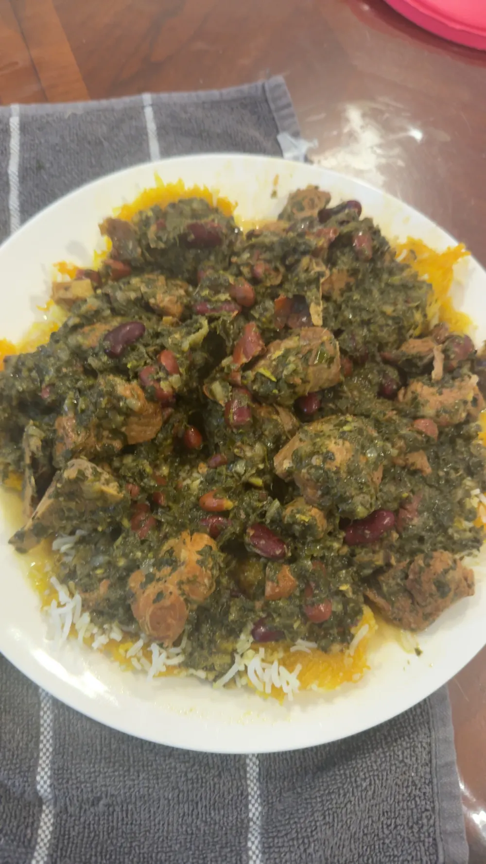 Ghormeh sabzi — Persian herb stew with lamb and kidney beans over saffron rice