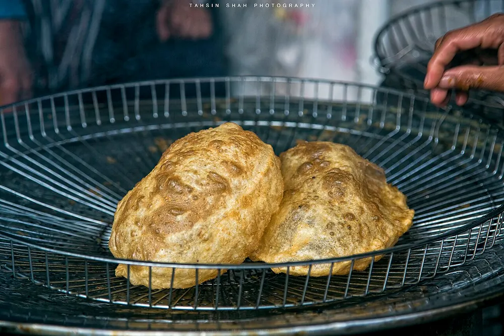 Halwa puri: puffed fried puris in a basket, from the Walled City of Lahore