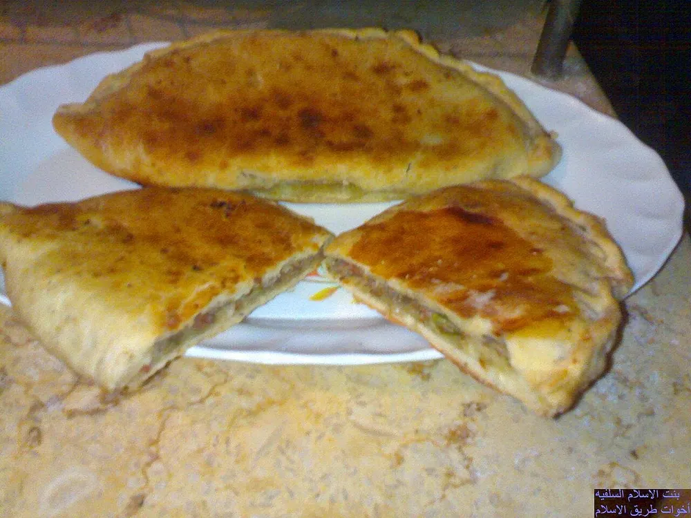 Hawawshi cut open to show the spiced minced-meat filling inside baladi bread
