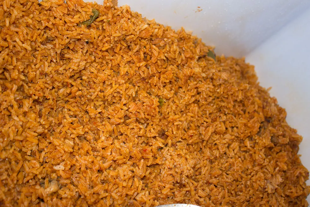 Long-grain rice cooked deep red-orange throughout, the grains separate