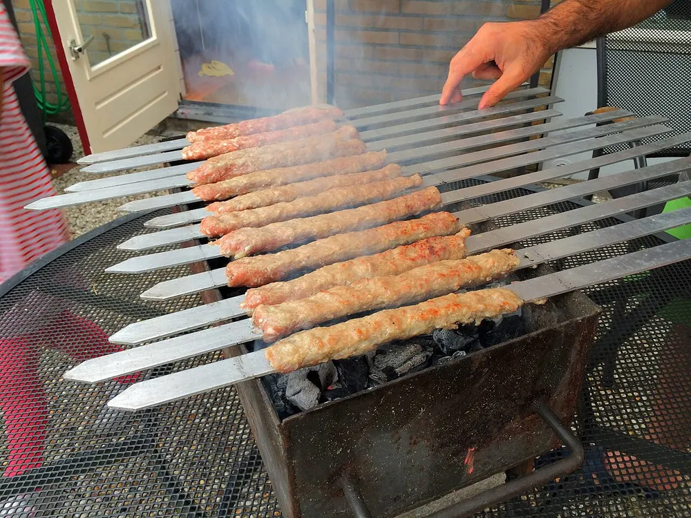 Kabab-e koobideh — minced-meat kebabs grilled on flat skewers over charcoal