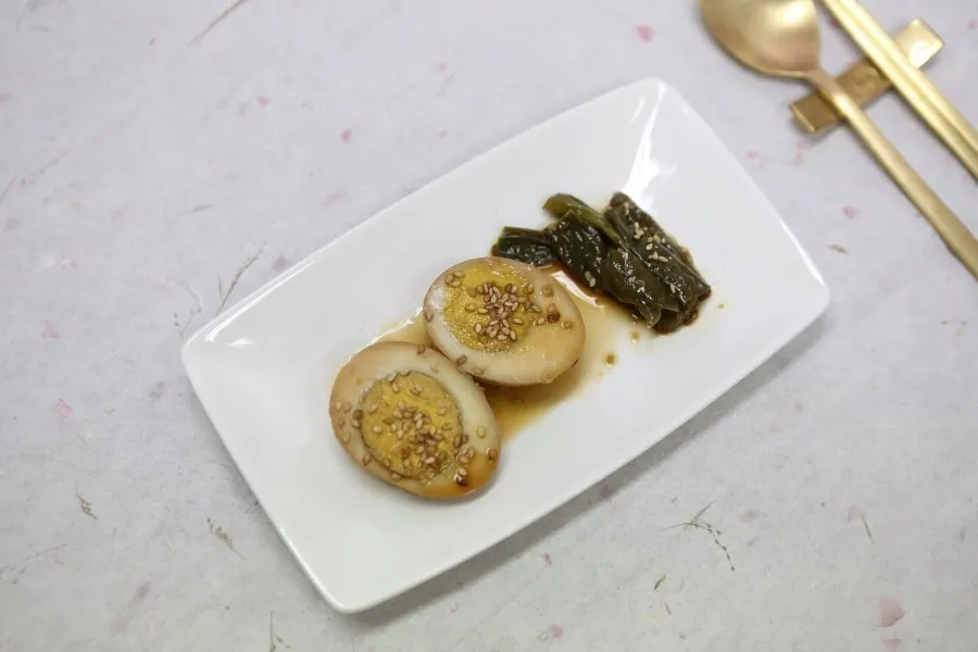Gyeranjang — soy-marinated eggs with sesame, served with pickled chilli