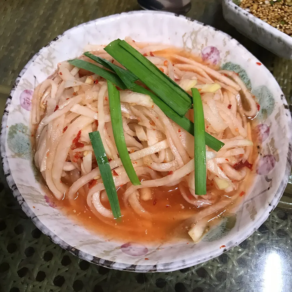 A bowl of musaengchae — julienned Korean radish dressed in chili and fish sauce
