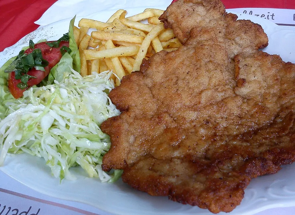 Kotlet schabowy — breaded fried pork cutlet with potatoes and cabbage salad