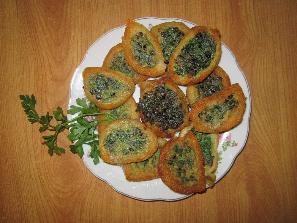 Slices of kuku sabzi, the Persian herb frittata, on a plate