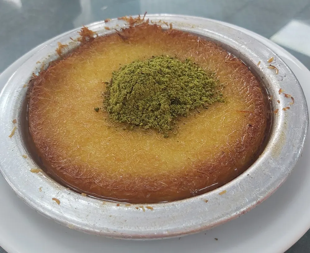 Künefe — shredded-pastry cheese dessert in syrup, topped with pistachio