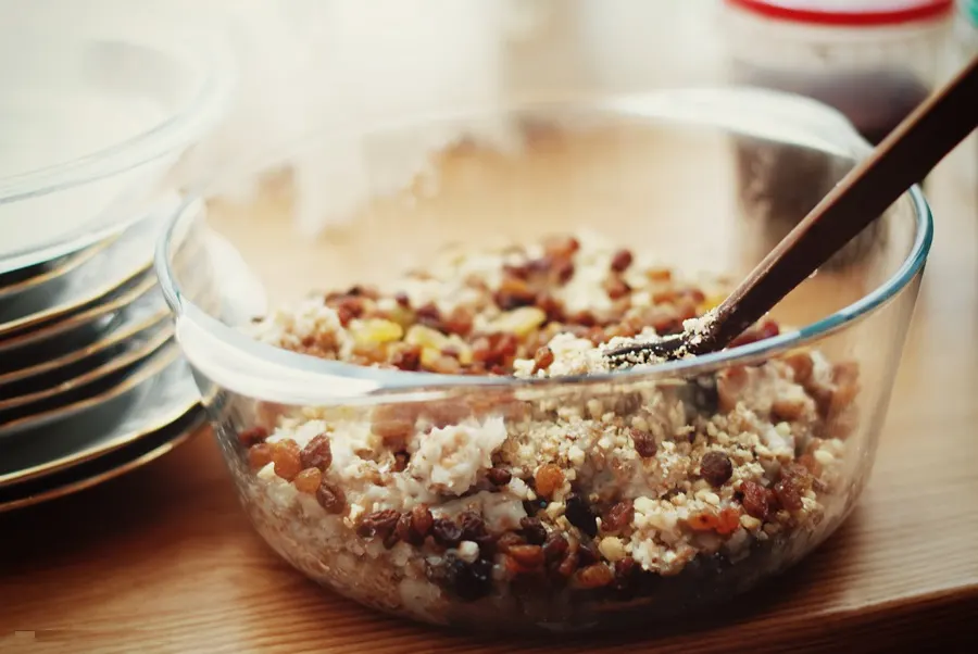 A glass bowl of kutia — cooked wheat berries with raisins, poppy seed and chopped nuts
