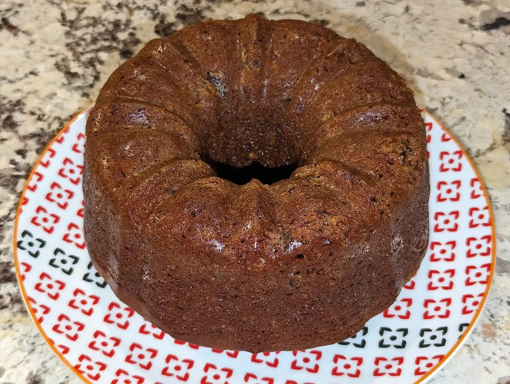 A dark honey medivnyk baked in a ring tin, glossy on top