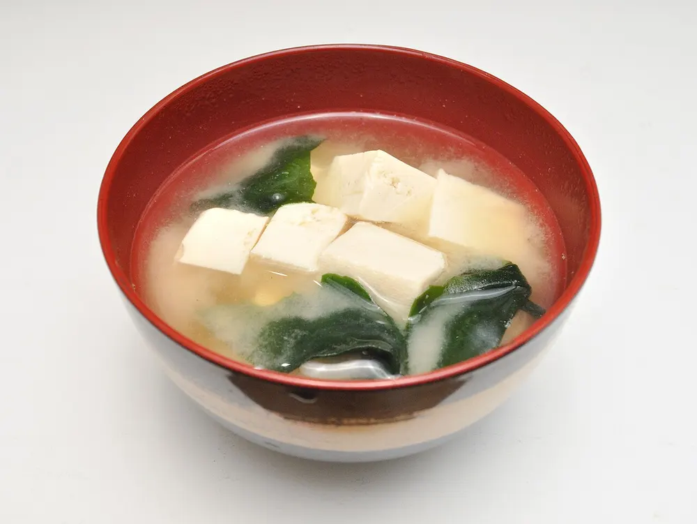 A bowl of miso soup with tofu and wakame