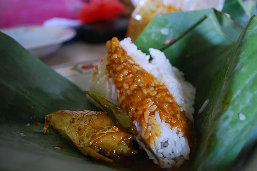 Nasi dagang with tuna curry on a banana leaf at Kuantan market