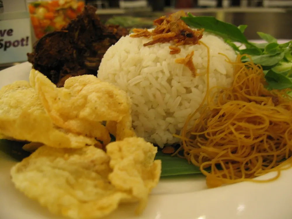 Nasi uduk — Betawi coconut-steamed rice with fried sides and crackers
