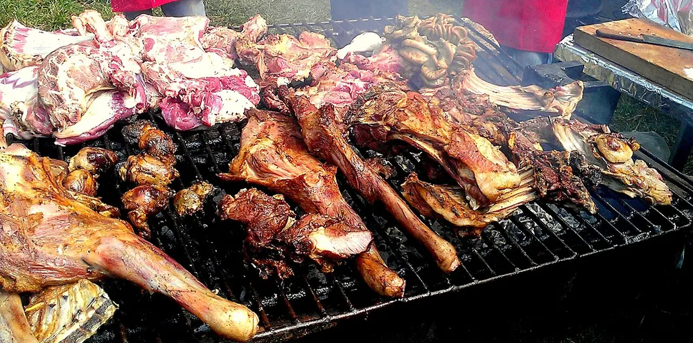Nyama choma — goat and beef grilling slowly over charcoal