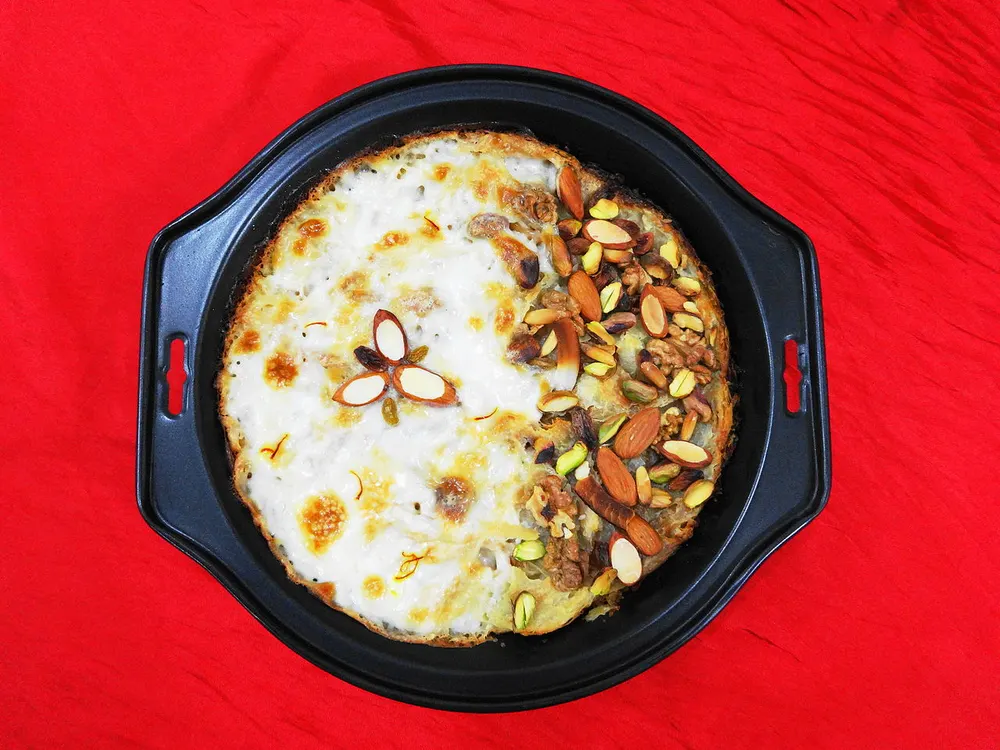 Om Ali — baked bread-and-milk pudding topped with nuts and saffron