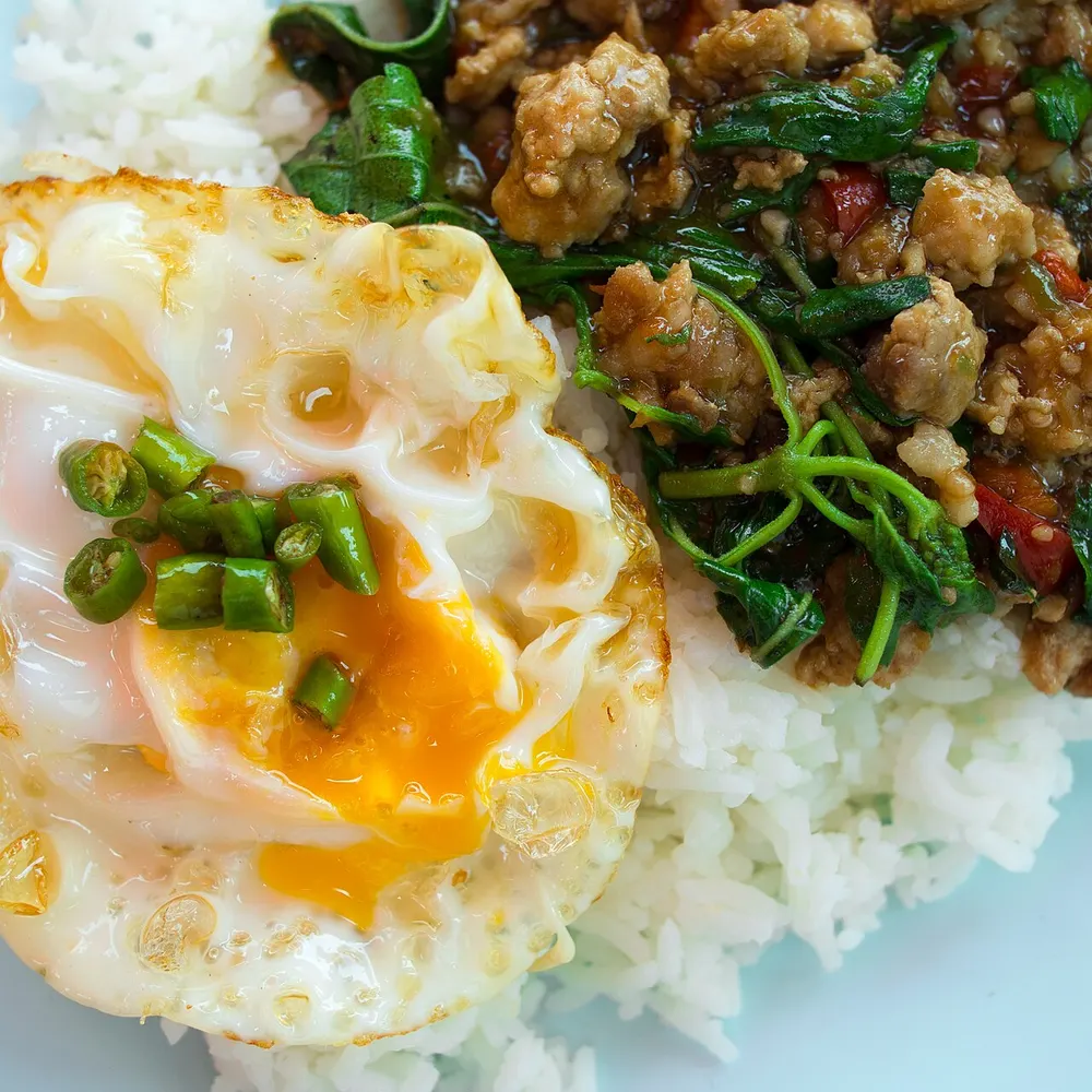 Pad kra pao moo — holy-basil minced pork over rice with a fried egg