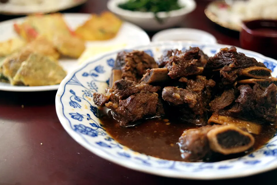 A plate of galbijjim — beef short ribs braised until dark and glossy in soy sauce