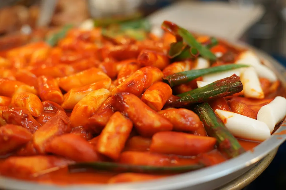 Tteokbokki rice cakes in glossy red gochujang sauce