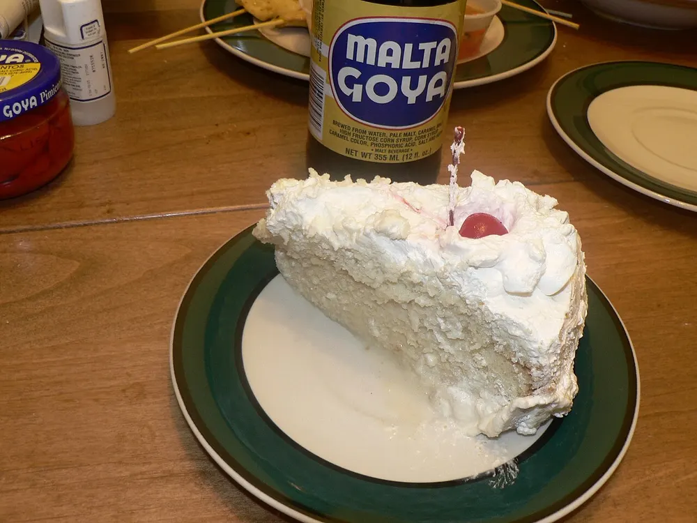 Tres leches cake — sponge soaked in three milks, topped with cream