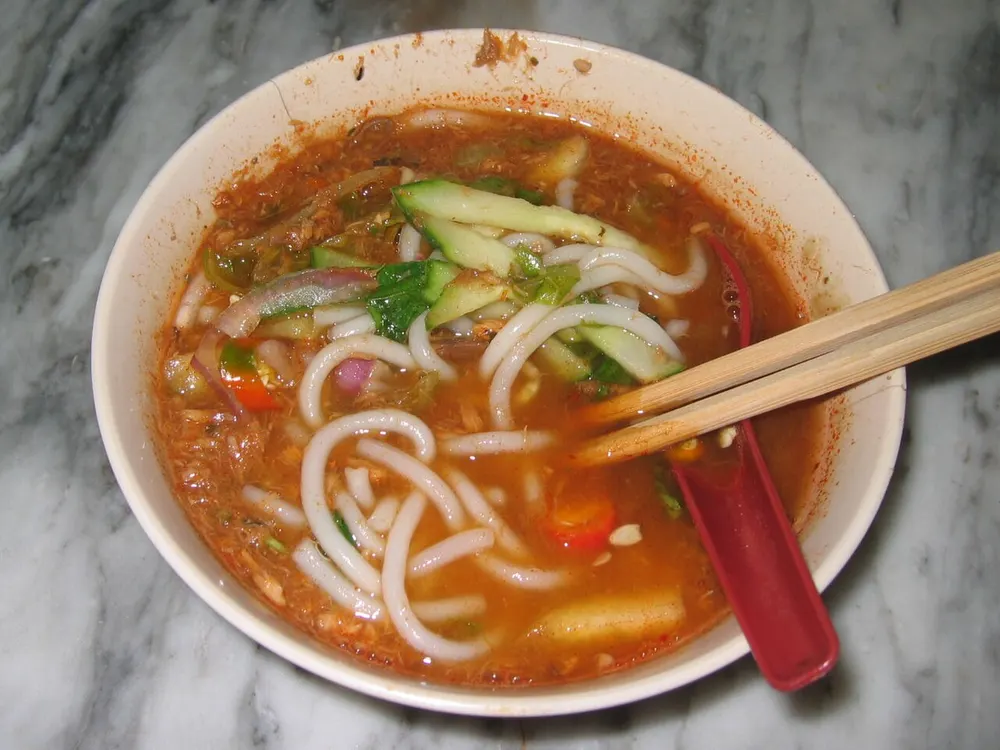 Penang asam laksa — thick rice noodles in a tangy tamarind-fish broth