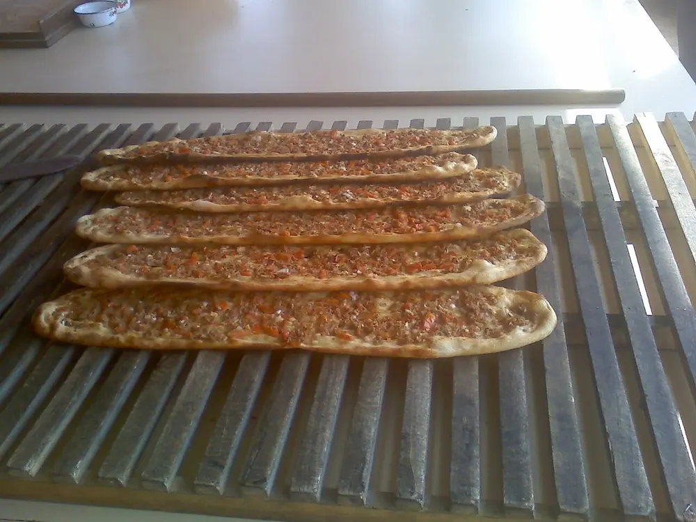 Boat-shaped pide flatbreads topped with spiced minced meat