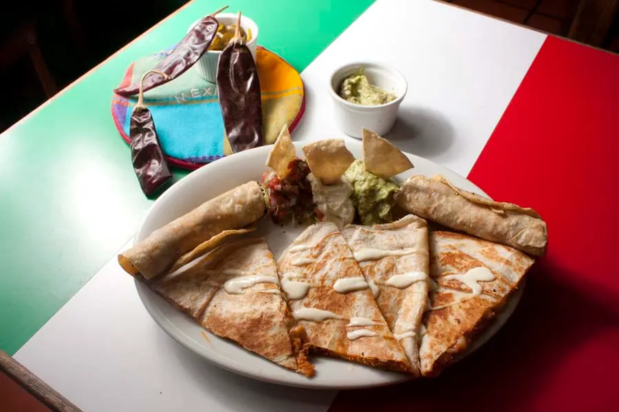 Cheese quesadillas with cream, served with guacamole and salsa