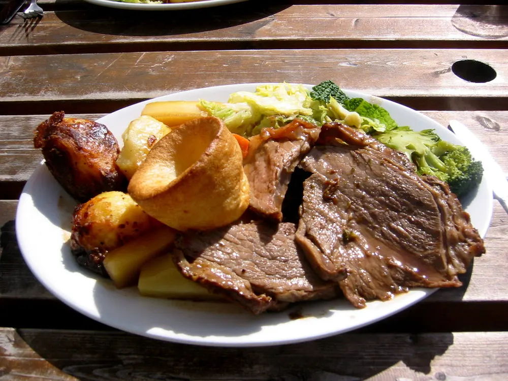 Roast beef and Yorkshire pudding — the classic British Sunday roast with gravy