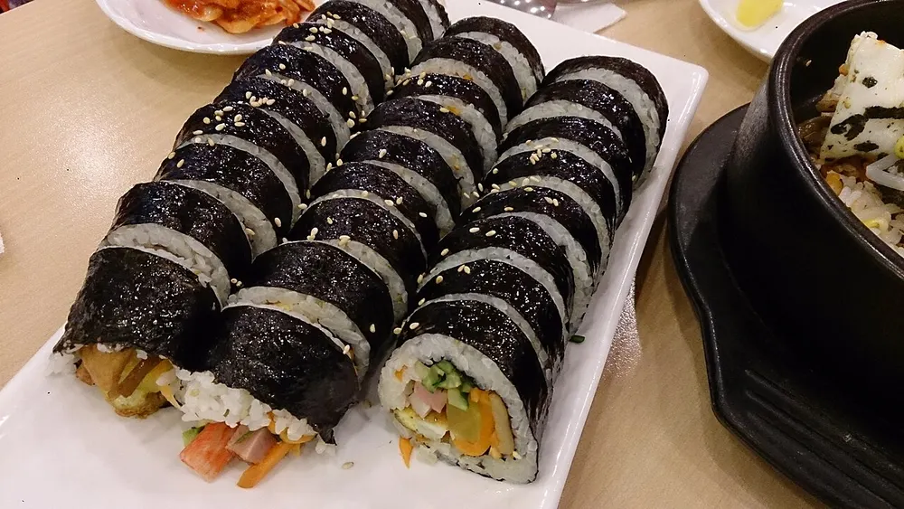 Gimbap rounds sliced and arranged on a plate